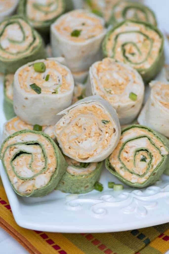 Tortilla rollups on a white platter.
