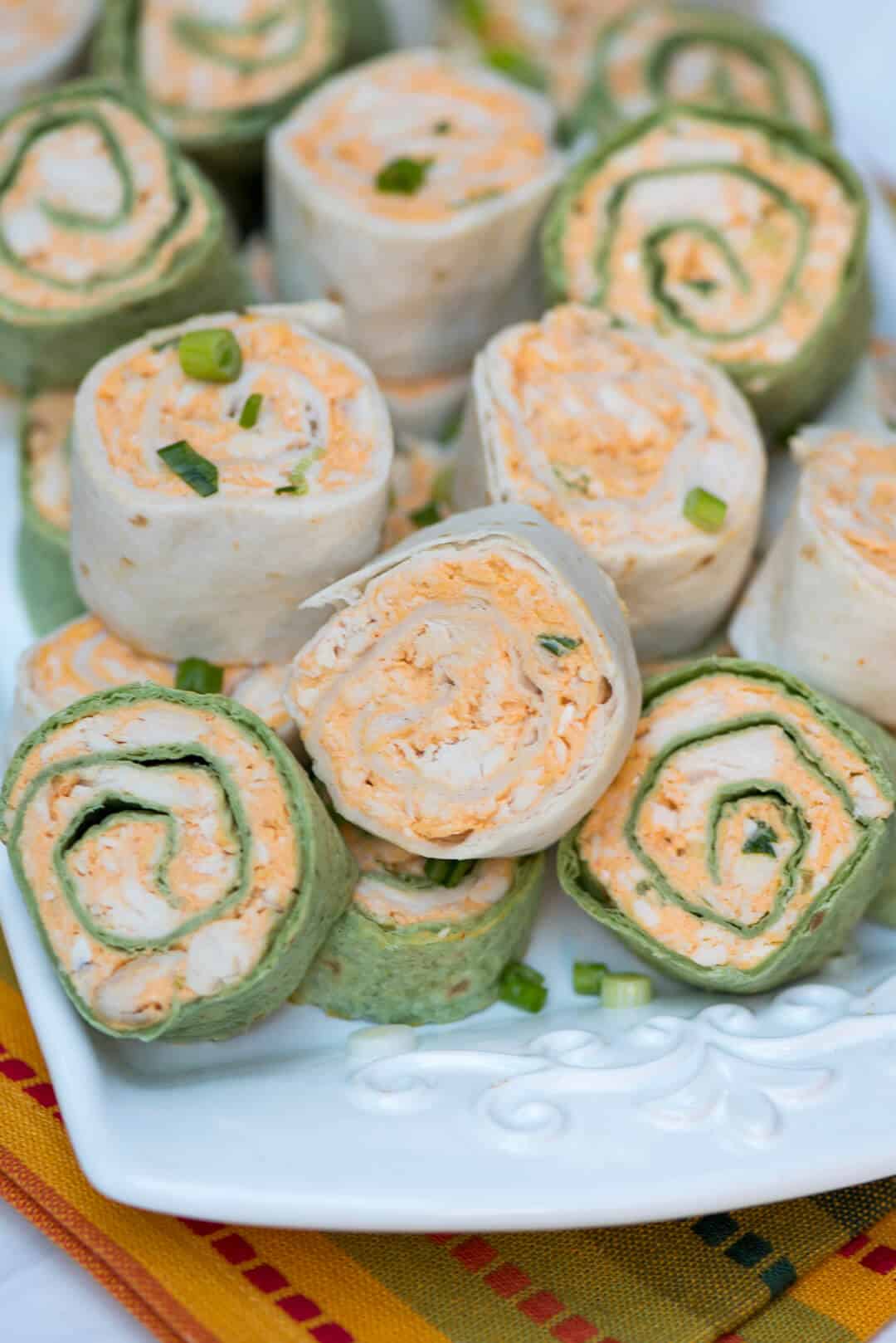 Tortilla rollups on a white platter.