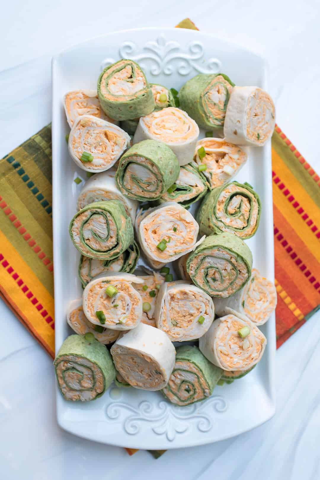 The totally irresistible flavor of Buffalo chicken wings all rolled up into a portable party snack. These Buffalo Chicken Tortilla Pinwheels are guaranteed to be a hit at your next gathering!