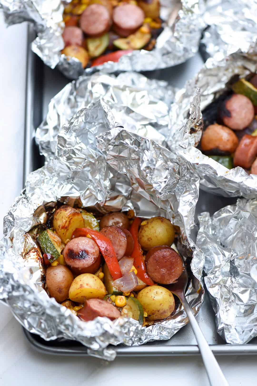 You just can't beat the foil pack method of cooking for an easy, stress-free summer meal. This Foil Pack Southwest Sausage and Potatoes takes just minutes to assemble, 15 minutes to cook, and cleanup is almost non-existent!
