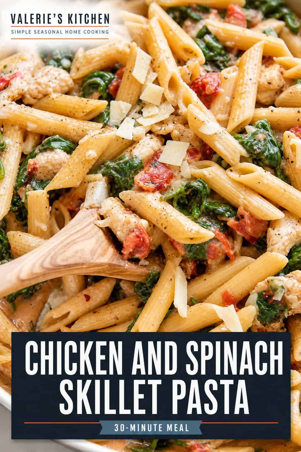 Pinterest graphic for Chicken and Spinach Skillet Pasta featuring a skillet filled with pasta, chicken, spinach, and tomatoes. The title "Chicken and Spinach Skillet Pasta" appears over the image.