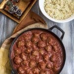 A skillet filled with meatballs and sauce.