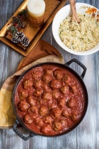 A skillet filled with meatballs and sauce.