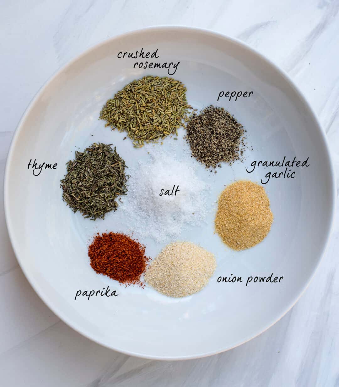 Instant Pot Pot Roast Rub - an assortment of dried herbs on a white dish