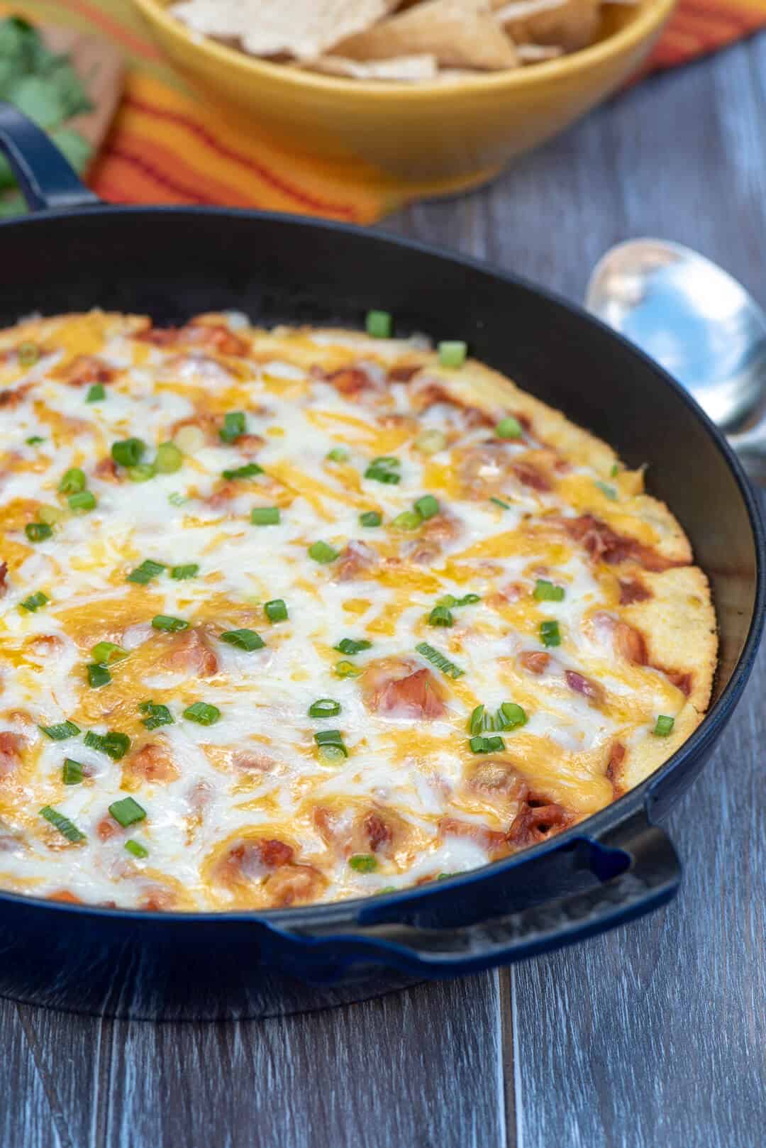 A close up of the BBQ Chicken Cornbread in a cast iron skillet.