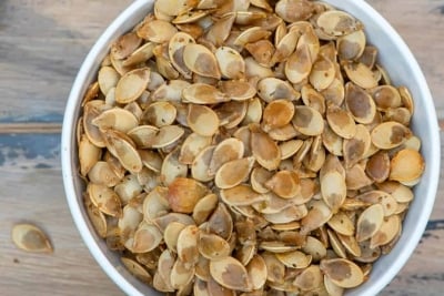 A bowl of roasted acorn squash seeds.