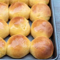A baking sheet filled with dinner rolls.