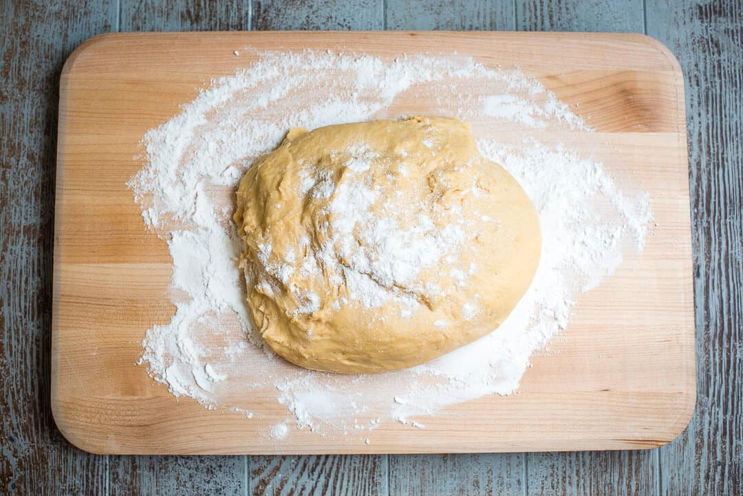 The dough on to a floured wooden board.