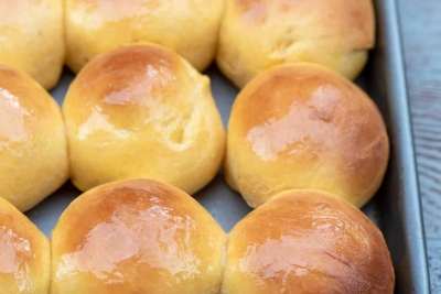 A baking sheet filled with dinner rolls.