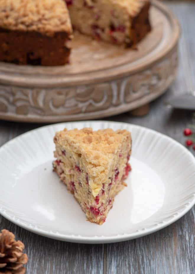 A slice of Cream Cheese Cranberry Coffee Cake on a white serving plate.