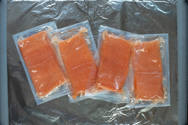 Kirkland Salmon fillets in packaging on a sheet of foil.