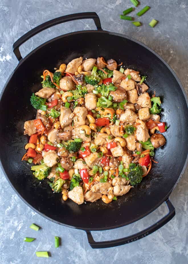 A wok shot from over the top filled with Cashew Chicken.