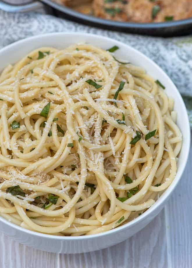 Cooked bucatini pasta tossed with Parmesan and basil.