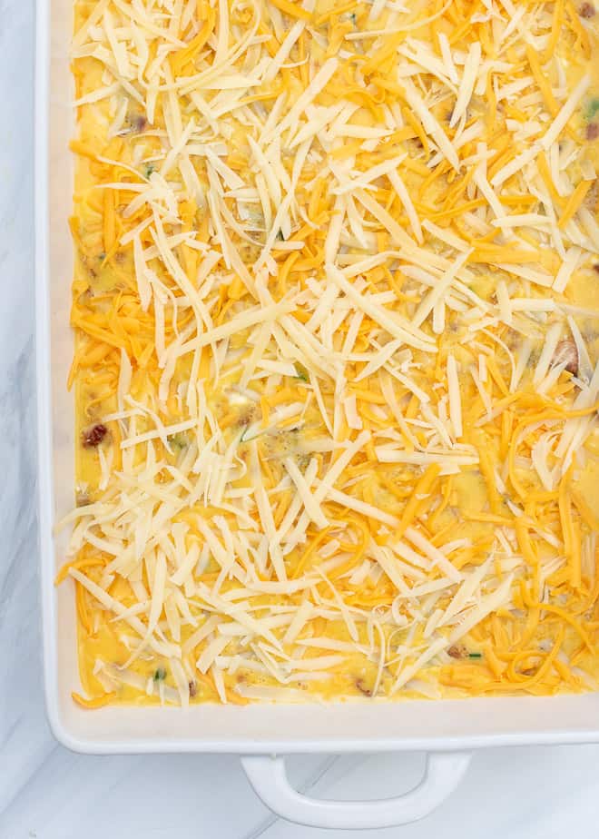 The egg mixture topped with shredded cheese.