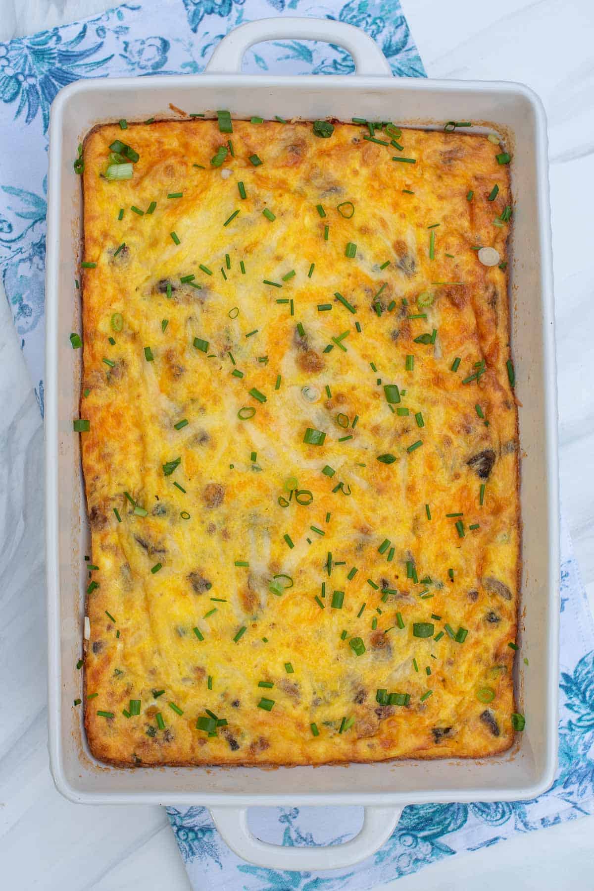 A baked quiche in a 13 by 9 baking dish.