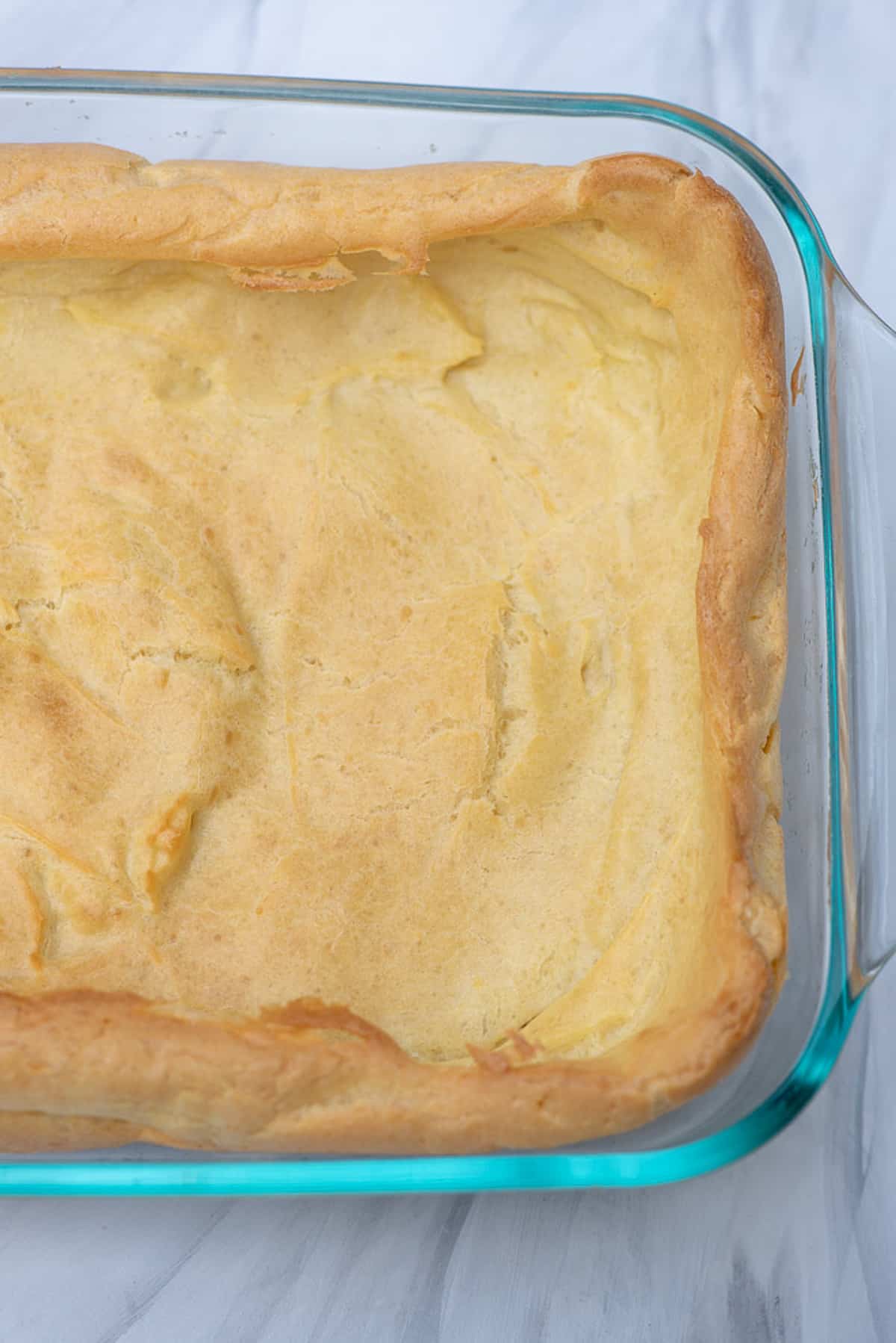 Cream puff pastry baked in a 13 by 9 baking dish.