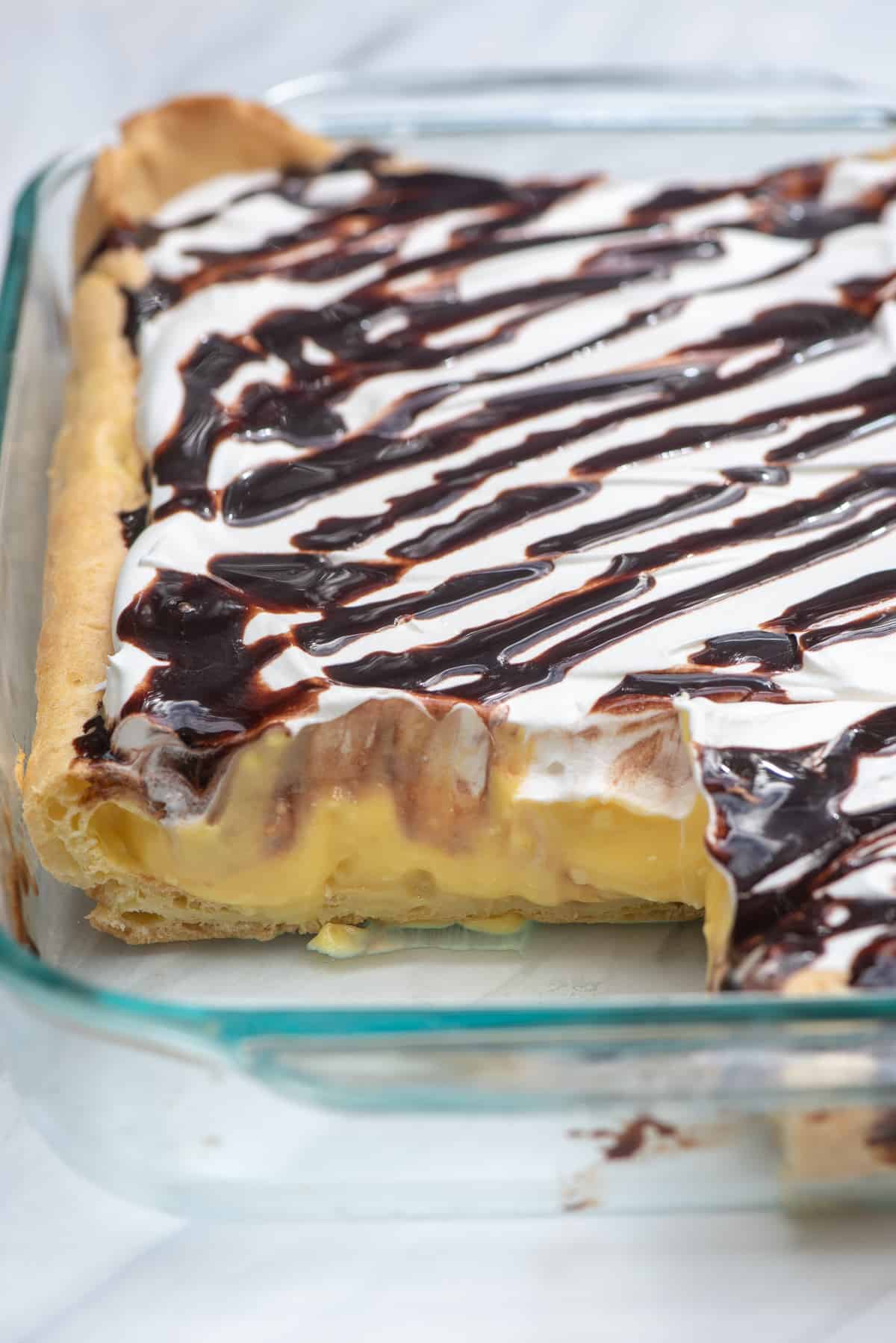 Cream Puff Dessert in a 13 x 9 inch baking dish with a couple of slices taken out.