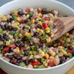 A bowl filled with a colorful bean salad.