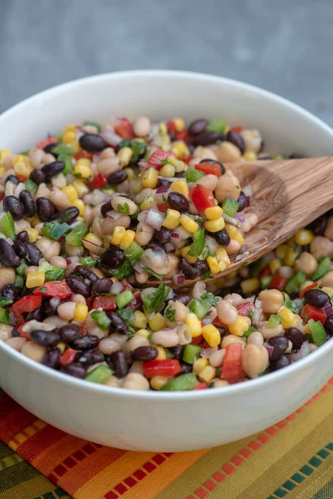 A bowl filled with a colorful bean salad.