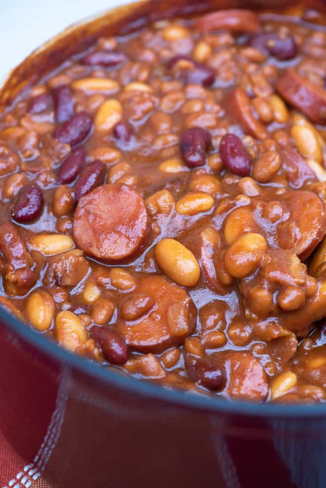 A close up shot of kielbasa (polish sausage) and beans.