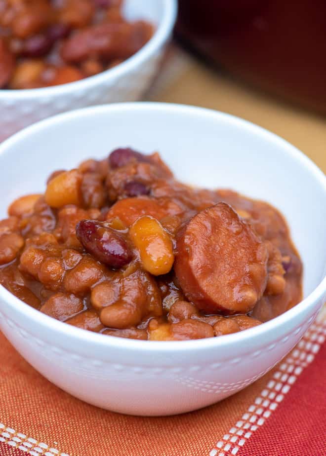 A single serving of Kielbasa Baked Beans in a small white bowl.