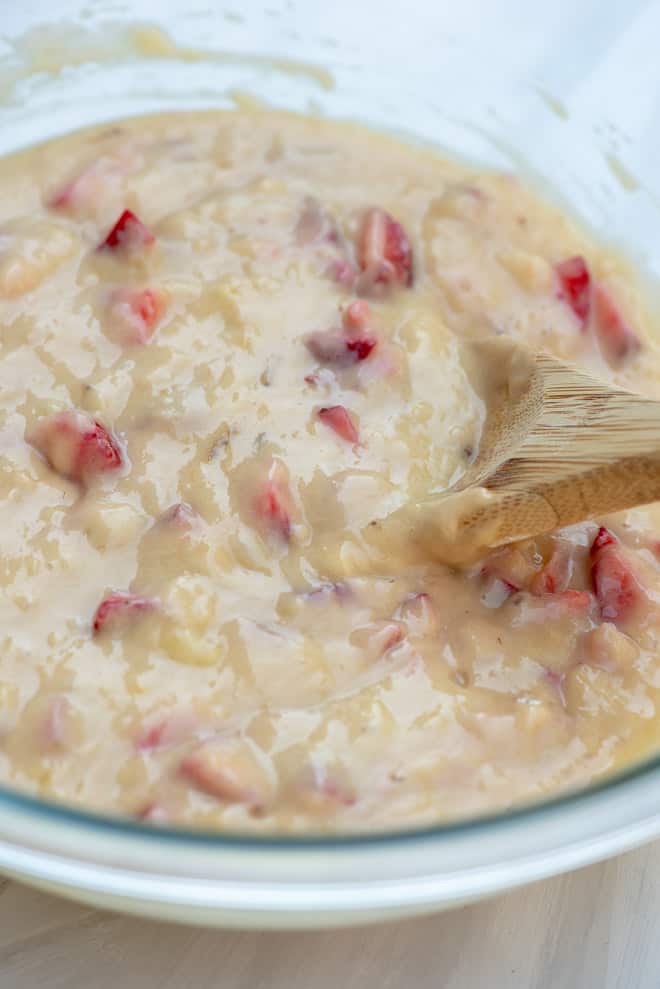 The batter mixed together in a glass mixing bowl.