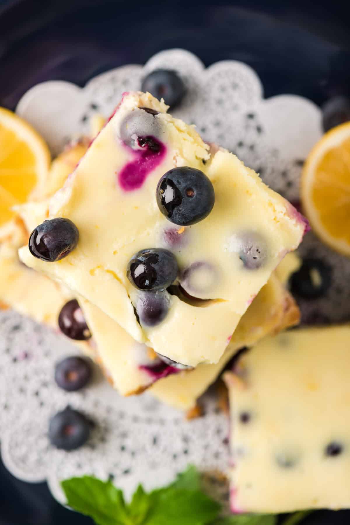 A close up image of Lemon Blueberry Cheesecake Bars shot from over the top.