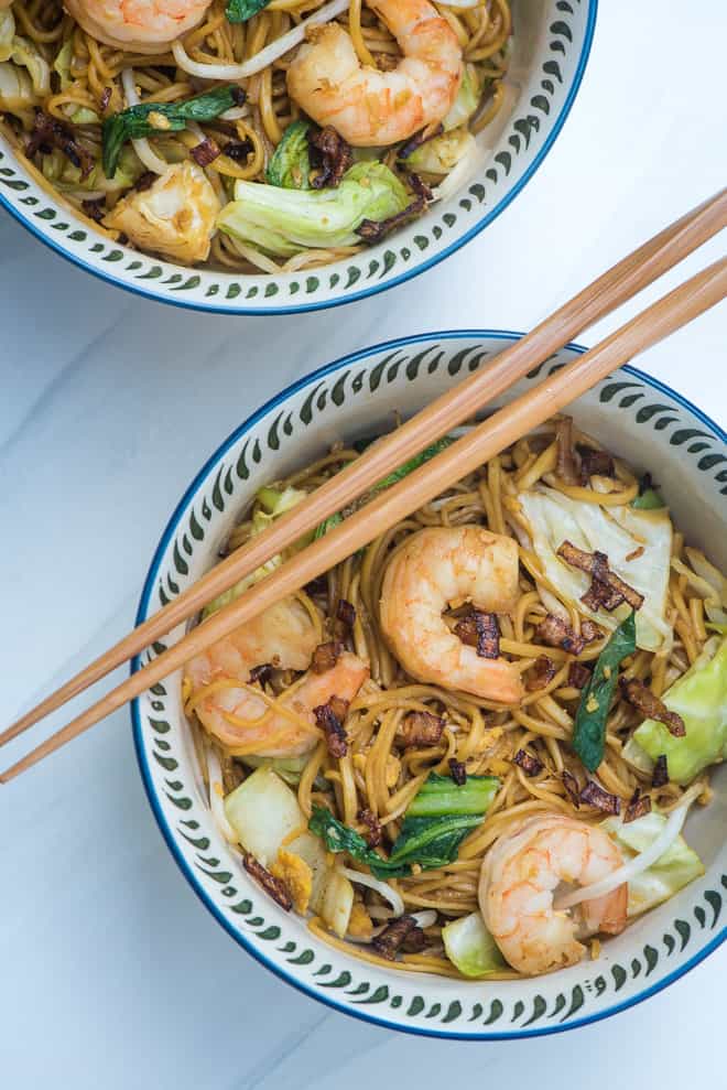 Stir Fried Noodles with Shrimp recipe (Easy Mie Goreng) in a patterned serving bowl with chop sticks laying over the top.