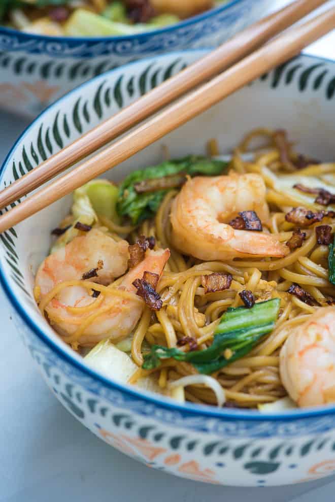 Stir Fried Noodles with Shrimp recipe (Easy Mie Goreng) in a patterned serving bowl with chop sticks laying over the top.