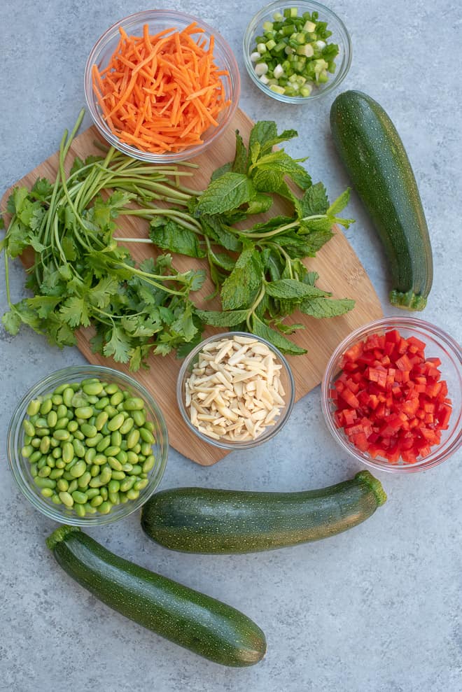 The Ingredients in Asian Zucchini Noodle Salad on a grey board.