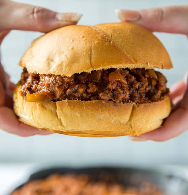 Hands hold a sloppy joe.