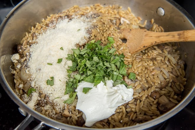Sour cream, Parmesan and chopped fresh basil are added to the saute pan.