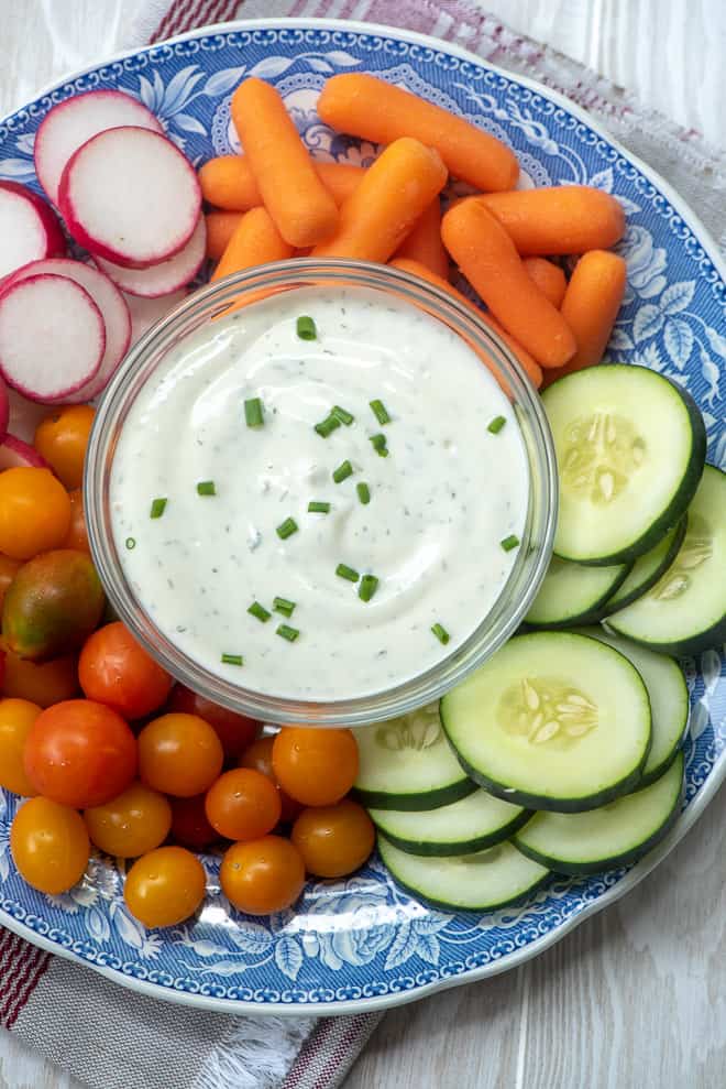 The Ranch dip is show in a small bowl on a platter of vegetables.