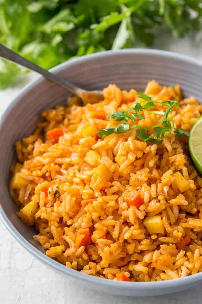 A serving of Restaurant Style Mexican Rice in small bowl with a fork.