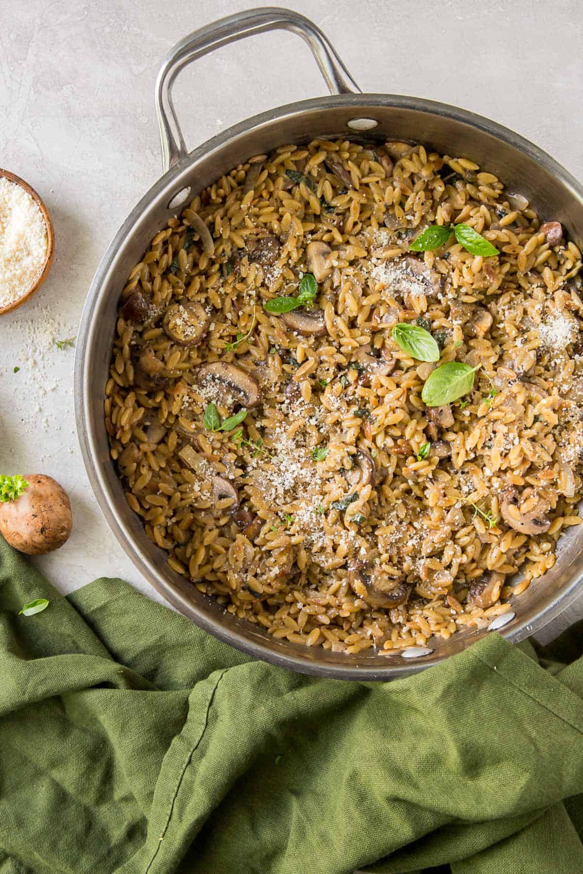 Orzo with mushrooms and parmesan in a skillet.
