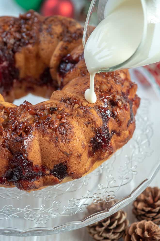 The glaze being poured on to the Cranberry Swirl Bundt Cake.