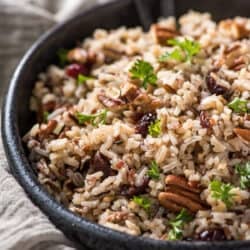 A bowl filled with Wild Rice Pilaf with Cranberries and Pecans.
