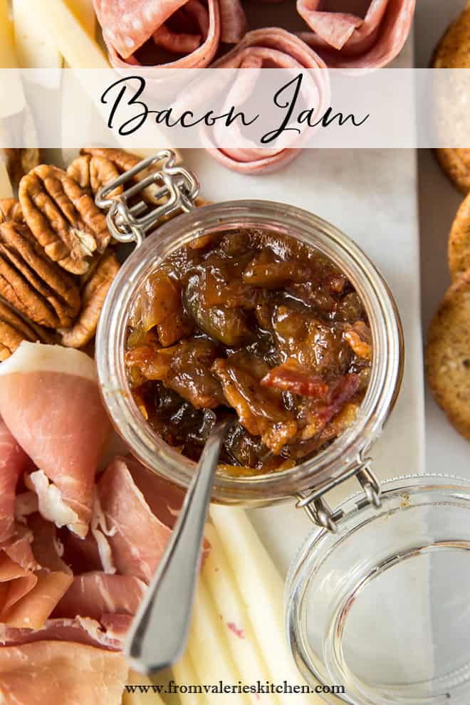 A top down shot of a spoon resting in a mason jar filled with bacon jam with text overlay.