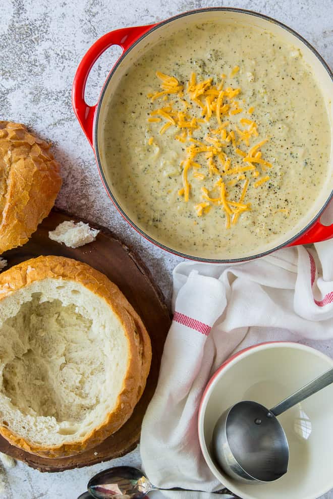 A shot from over the top of Broccoli Cheese Soup topped with cheddar cheese.