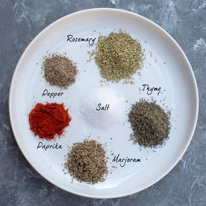 The spices in the Beef Stew Spice Mix on a white plate with overlay text.