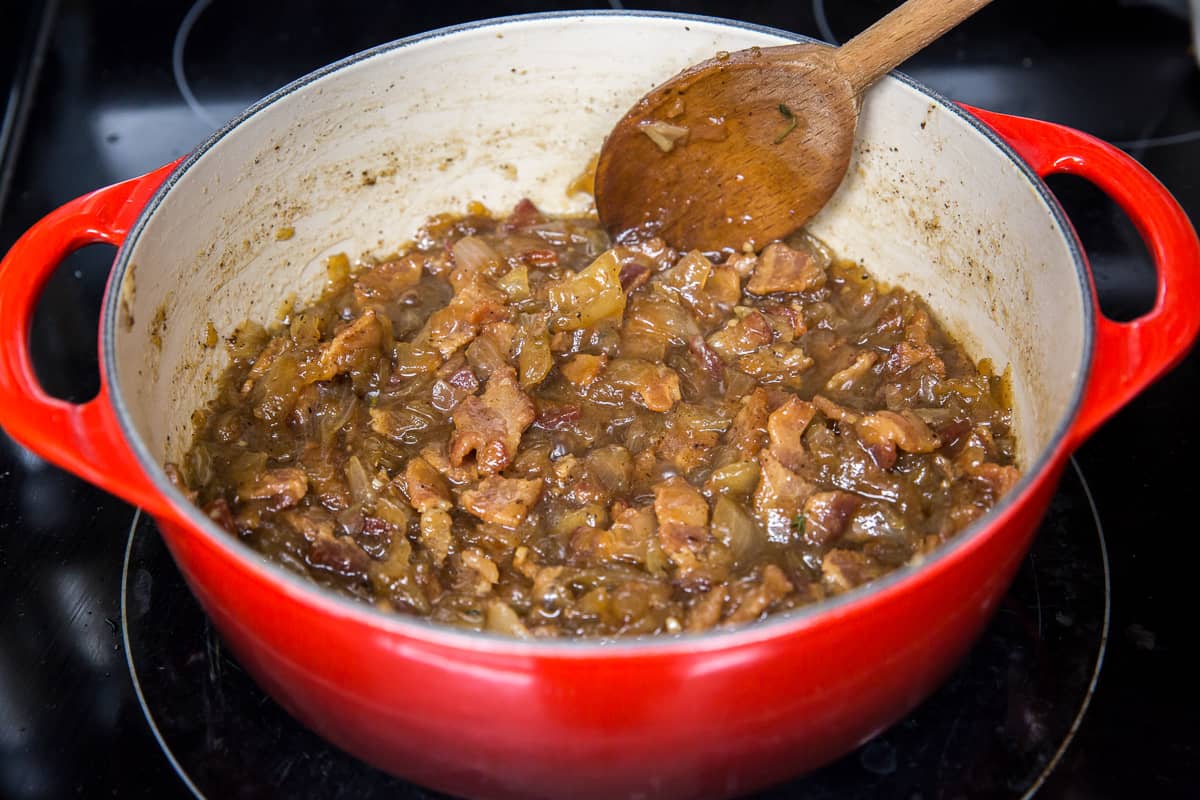 Bacon jam cooking in a pot on the stove.