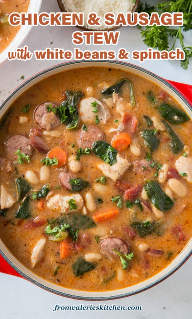 A top down shot of a pot filled with chicken and sausage stew with white beans and spinach with text.