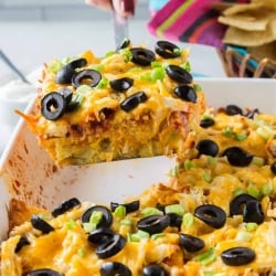 A spatula lifts a piece of casserole from a baking dish.