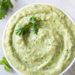 A small white bowl filled with tomatillo avocado salsa.