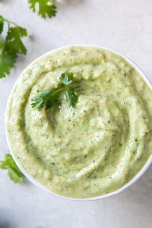 A small white bowl filled with tomatillo avocado salsa.