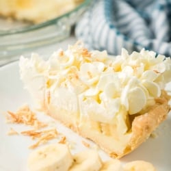 A slice of Banana Cream Pie on a serving plate with sliced bananas.