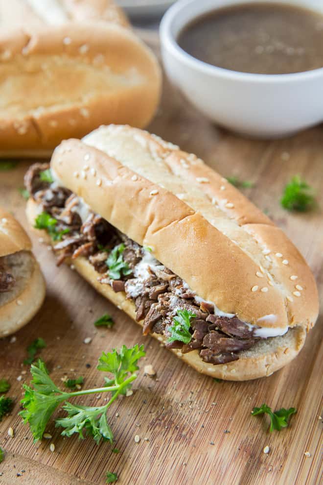 A French Dip sandwich with Creamy Horseradish Spread on a cutting board.