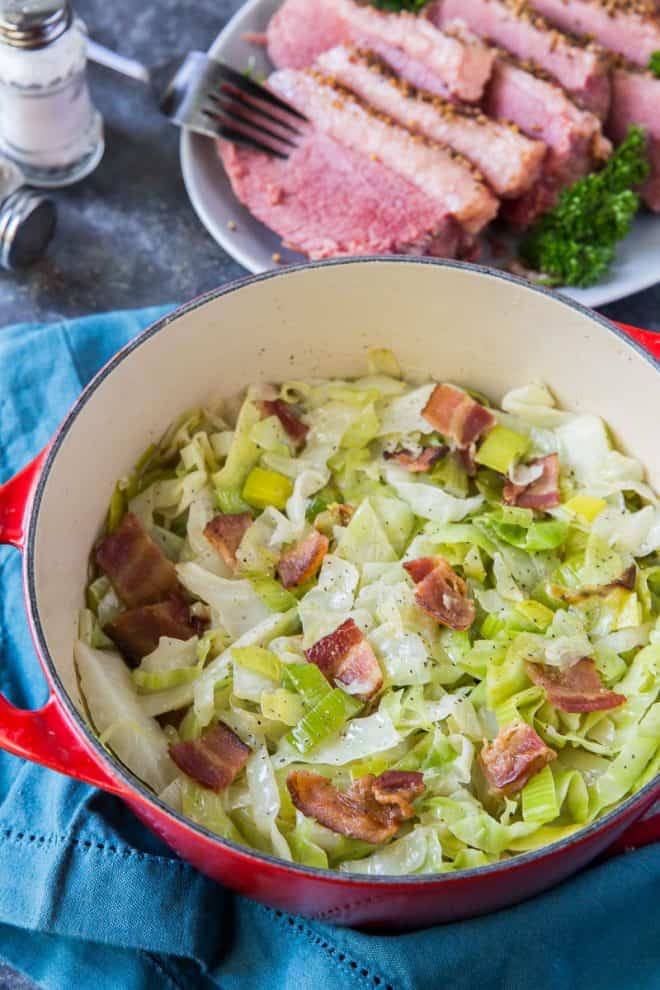 An overhead shot of the cooked cabbage in a red Dutch oven.