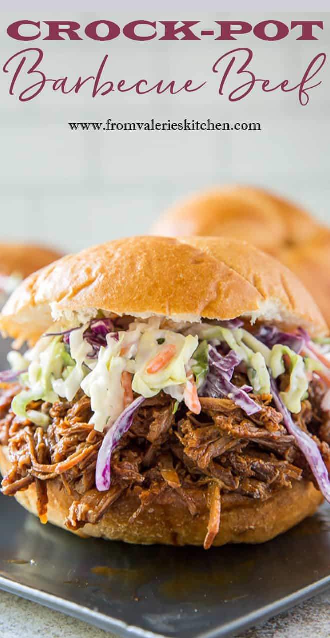 A close up image of Crock-Pot Barbecue Beef on a sandwich bun with coleslaw with overlay text.