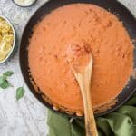 Tomato Cream Sauce in a skillet with a wooden spoon.